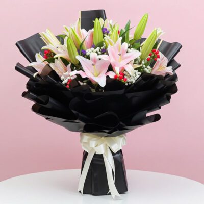 A vibrant bouquet featuring pink and white lilies arranged elegantly.