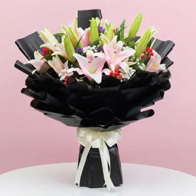 A vibrant bouquet featuring pink and white lilies arranged elegantly.