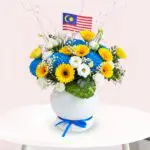 A white vase adorned with a blue ribbon, elegantly showcasing its decorative design.