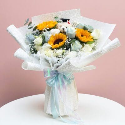 A Cheerful Arrangement Of Sunflowers And White Roses, Symbolizing Blossom Bliss Graduation.