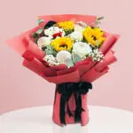 A Bright Bouquet Of Sunflowers With Cuddly Teddy Bears, Creating A Delightful And Sunny Floral Display.