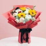 A Bright Bouquet Of Sunflowers With Cuddly Teddy Bears, Creating A Delightful And Sunny Floral Display.