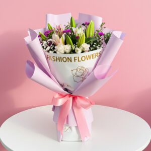 A vibrant bouquet of lilies featuring the phrase "Fashion Flowers" artistically integrated into the arrangement.