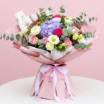 A vibrant bouquet of pink and purple flowers arranged elegantly.