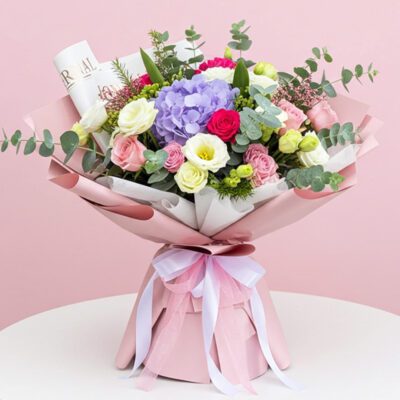 A vibrant bouquet of pink and purple flowers arranged elegantly.