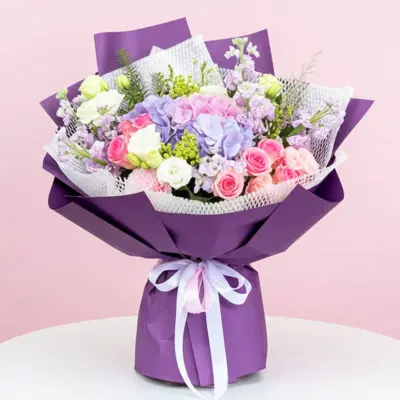 A vibrant purple bouquet featuring pink and white flowers arranged elegantly.