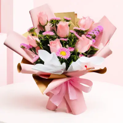 A bouquet of pink and purple roses arranged in a brown paper bag, showcasing soft elegance and charm.