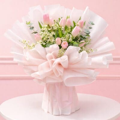 A beautiful bouquet featuring pink tulips, Saxifrage, and greenery, designed to bring freshness and charm to any occasion.