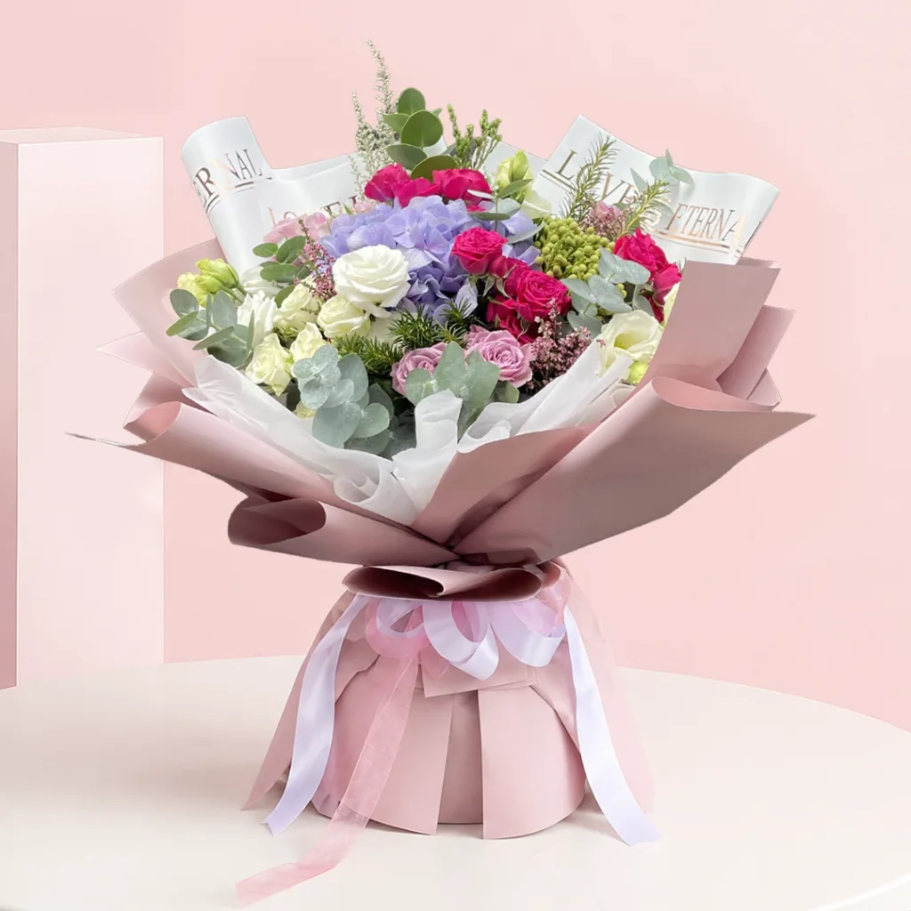 A vibrant bouquet of pink and purple flowers arranged elegantly.