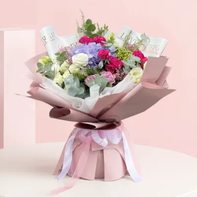 A vibrant bouquet of pink and purple flowers arranged elegantly.