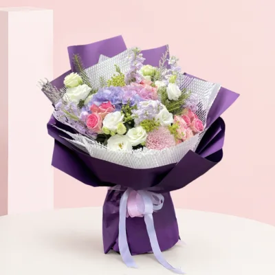 A vibrant purple bouquet featuring pink and white flowers arranged elegantly.