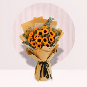 A vibrant bouquet of sunflowers with a few leaves of eucalyptus.