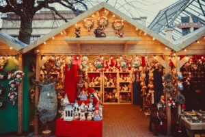 The wooden stalls create a warm and inviting atmosphere, reminiscent of traditional Christmas markets.