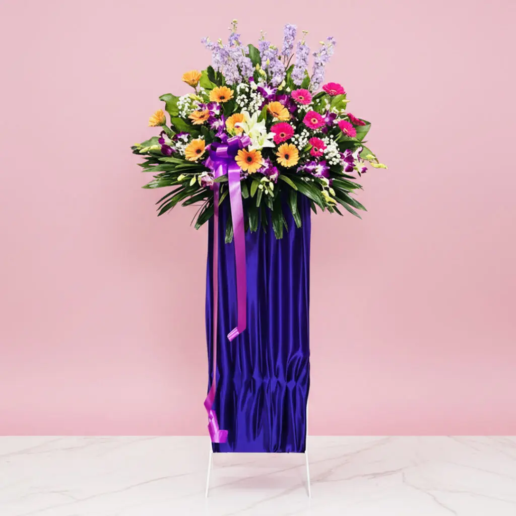 A large purple vase adorned with colorful flowers, showcasing a vibrant floral arrangement.