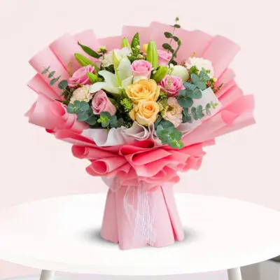 A vibrant bouquet featuring pink and yellow roses arranged elegantly together.