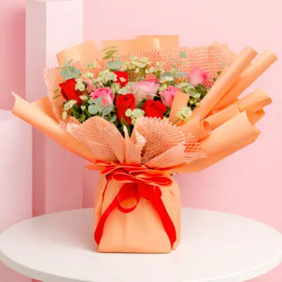 A charming bouquet of peach roses presented in a stylish