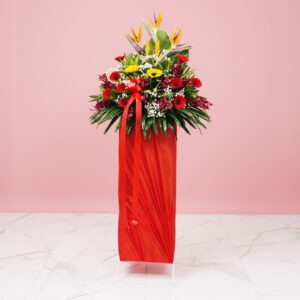 A Cheerful Arrangement Of Yellow And Red Daisies In A Red Color, Displayed On A Pink Background, Ideal For Festive Occasions.
