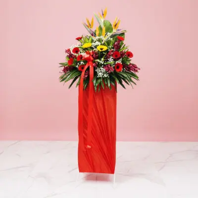 A Cheerful Arrangement Of Yellow And Red Daisies In A Red Color, Displayed On A Pink Background, Ideal For Festive Occasions.