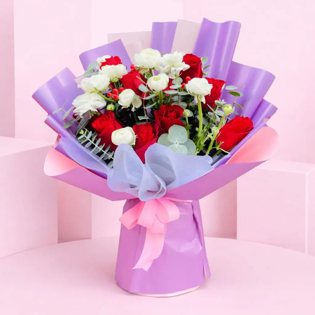 A bouquet of red and white roses arranged in a table