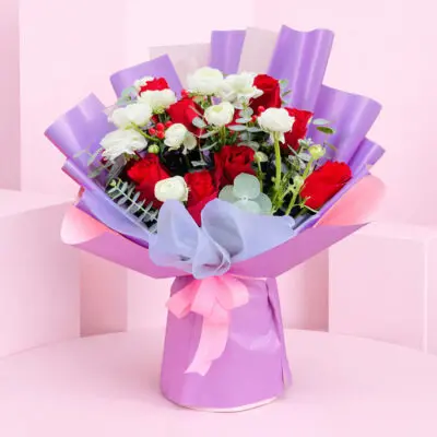 A bouquet of red and white roses arranged in a table