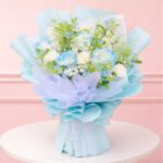 A vibrant bouquet of blue flowers arranged elegantly on a wooden table.