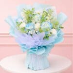 A vibrant bouquet of blue flowers arranged elegantly on a wooden table.