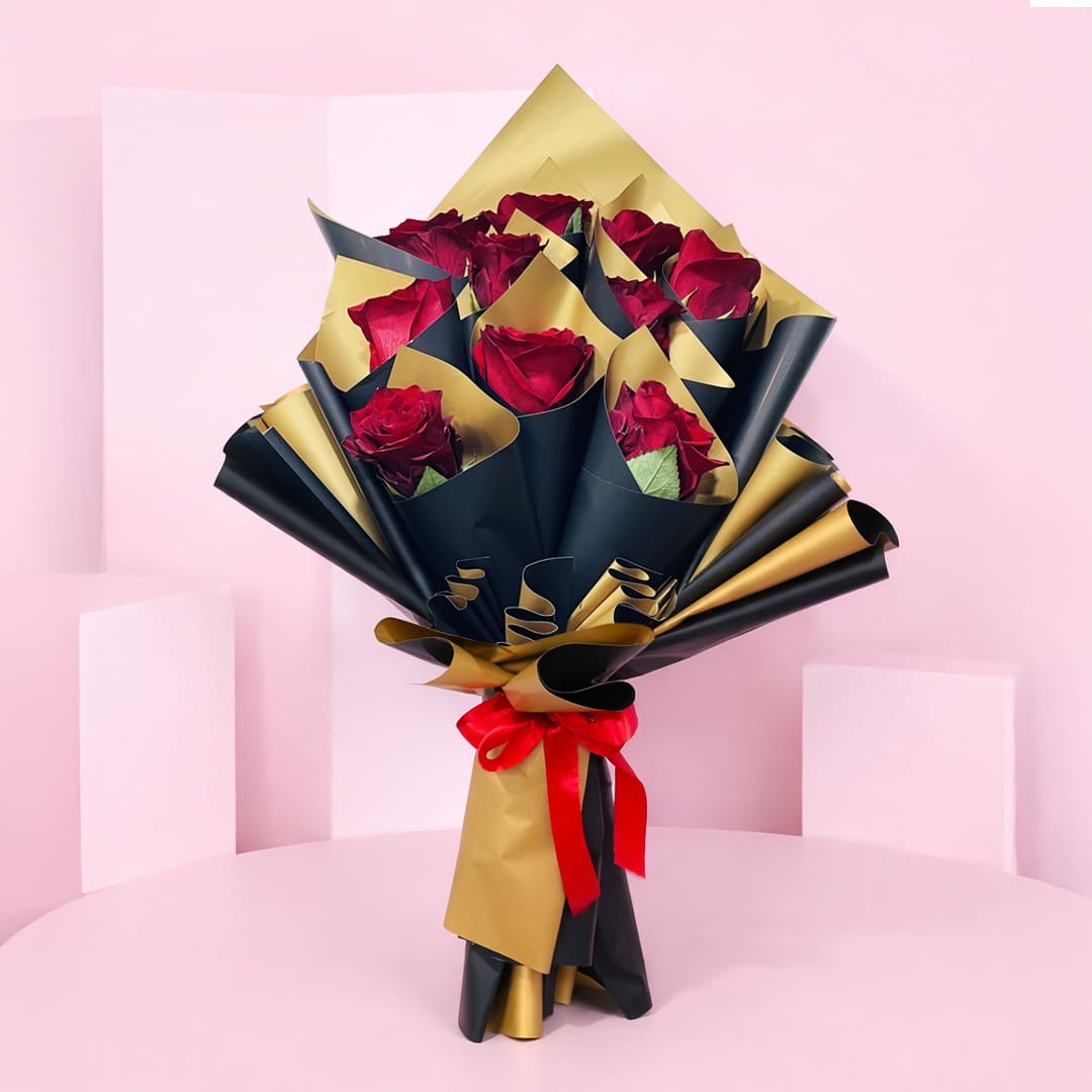 red-roses-royale-2026_01 A bouquet of vibrant red roses elegantly wrapped in shimmering gold foil.