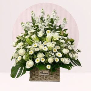 White Lilies: Several white lilies are interspersed throughout, contributing to the arrangement's height and elegance.