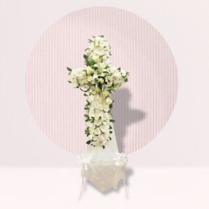 Cross Shape: The arrangement is clearly shaped like a cross, a traditional symbol of Christianity often used in funeral and memorial services.
