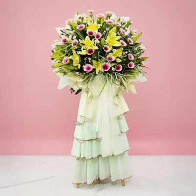 A Large, Colorful Flower Arrangement In A Vase On A Pink Background, Representing Success And Fresh Starts.