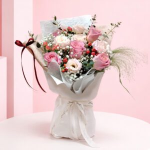 A charming bouquet of pink roses with wispy baby's breath interspersed throughout.