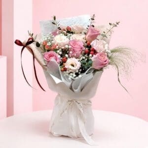 A charming bouquet of pink roses with wispy baby's breath interspersed throughout.