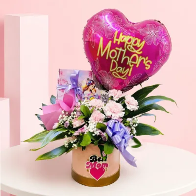 A flower box with pink carnations and baby’s breath, topped with a “Happy Mother’s Day” balloon and greeting card.