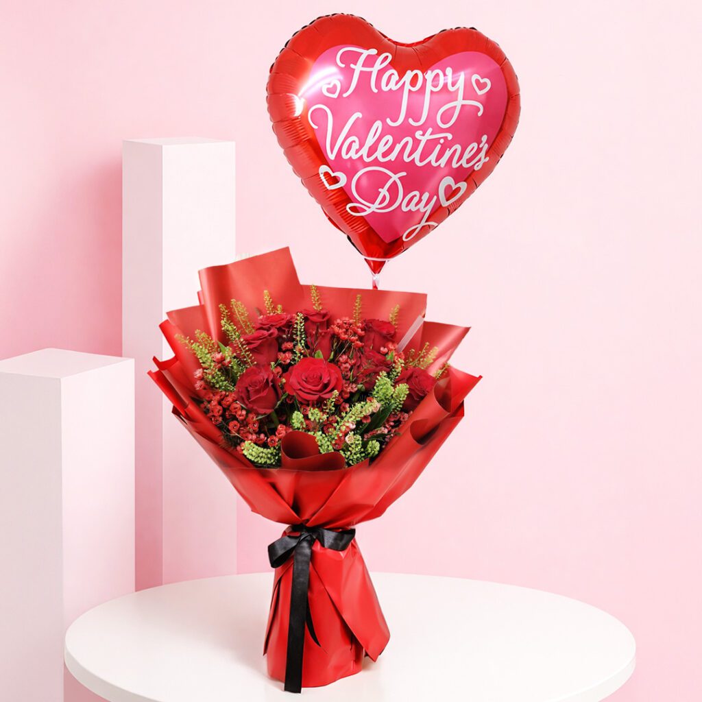 Red rose valentine balloon bouquet with seasonal fillers and greens in premium red wrapping, with a Happy Valentine’s Day heart balloon message