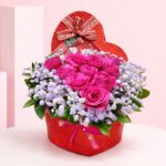 Valentine Pink Rose Box arrangement with hot pink roses and baby’s breath, finished with a “love you forever” ribbon.