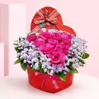 Valentine Pink Rose Box arrangement with hot pink roses and baby’s breath, finished with a “love you forever” ribbon.
