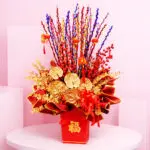 Prosperity flower Box with Lucky stems, red berry accents, and gold foliage in a red Chinese New Year box arrangement, finished with hanging CNY ornaments
