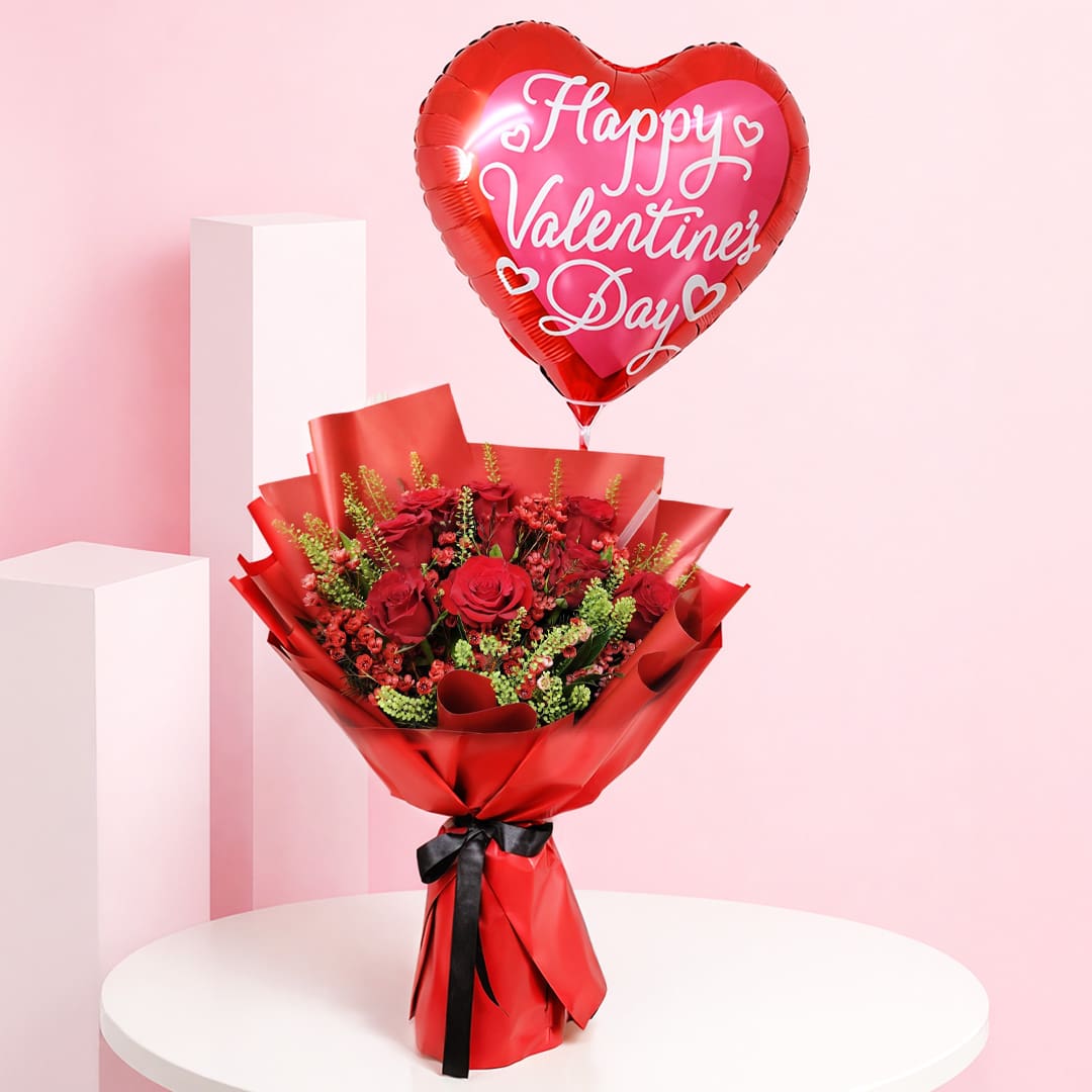 01 Red rose valentine balloon bouquet with seasonal fillers and greens in premium red wrapping, with a Happy Valentine’s Day heart balloon message