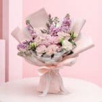 featuring pink hydrangea bouquet seasonal pink flowers and delicate fillers in blush wrapping, finished with a soft ribbon bow.