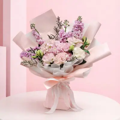 featuring pink hydrangea bouquet seasonal pink flowers and delicate fillers in blush wrapping, finished with a soft ribbon bow.