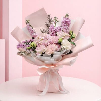 featuring pink hydrangea bouquet seasonal pink flowers and delicate fillers in blush wrapping, finished with a soft ribbon bow.