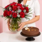 Chocolate Cheesecake & Flowers Combo featuring 15 red roses and 5 alstroemerias arranged in a vase paired with a rich chocolate cheesecake made with cream cheese, dark chocolate, and walnuts.