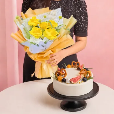 Golden Flowers & Chiffon Cake Combo featuring a hand bouquet of yellow roses and seasonal flowers paired with a pandan chiffon cake made with gula melaka and coconut mousse.