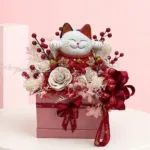 Lucky Cat Dry Flowers Bloom Box featuring a decorative lucky cat arrangement accented with elegant soap flowers and preserved dry flowers in a stylish gift box.