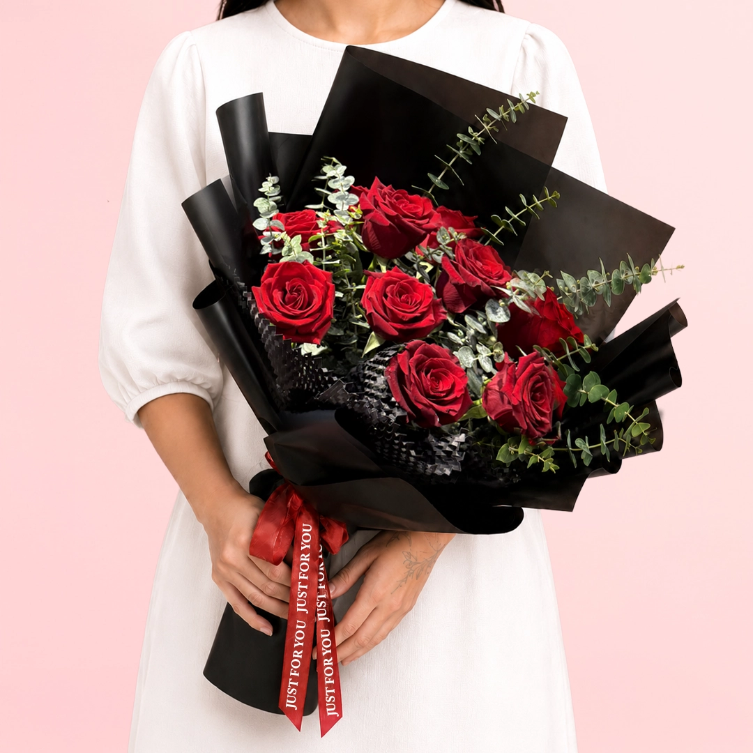 luxury-red-rose-bouquet Luxury Red Rose Bouquet featuring vibrant red roses arranged with textured greenery and wrapped in a sleek contemporary style for elegant gifting and special occasions.