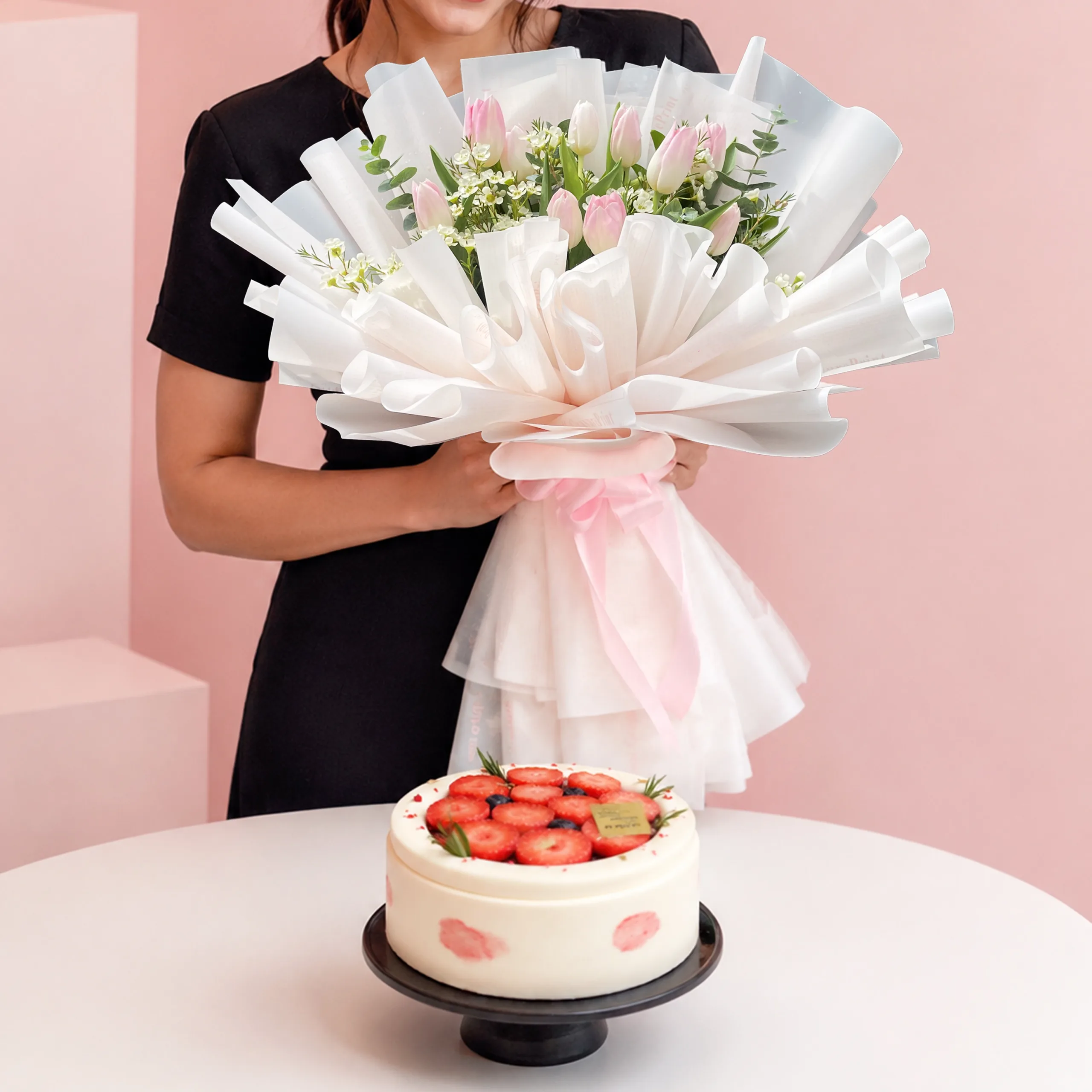 pink-flowers-chiffon-cake-combo Pink Flowers & Chiffon Cake Combo featuring a hand bouquet of 10 pink tulips with greenery paired with a vanilla chiffon cake filled with lychee mousse and lychee fruit.