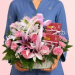 PopoMama Women's Gift Hamper featuring fresh lilies, carnations, baby’s breath, and PopoMama 5 in 1 Red Date Beverage beautifully arranged in an elegant gift basket.