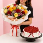 Rose Bouquet Velvet Cake Combo featuring a hand bouquet of 15 assorted roses with greenery paired with a Black Forest cake made with chocolate chiffon, fresh cream, and dark sweet cherries.