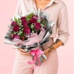 Royal Pink Rose Bouquet featuring deep pink roses, hypericum berries, and delicate gypsophila arranged in an elegant and luxurious floral design.