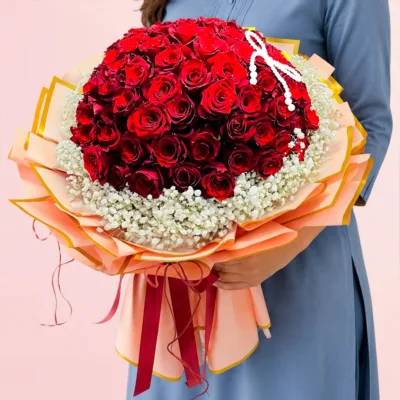 83 red roses arranged in premium wrapping and tied beautifully with a red satin ribbon.